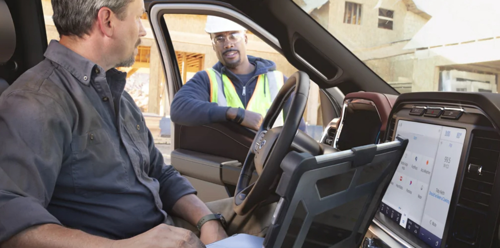 Two construction workers discussing the project in a F-150.