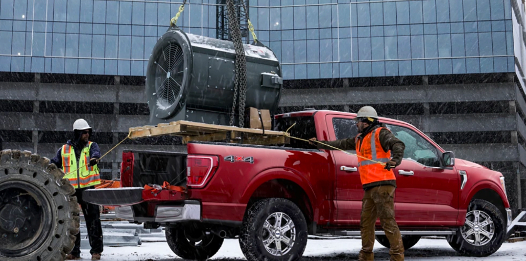 Heavy load lowered into a F-150 pickup.