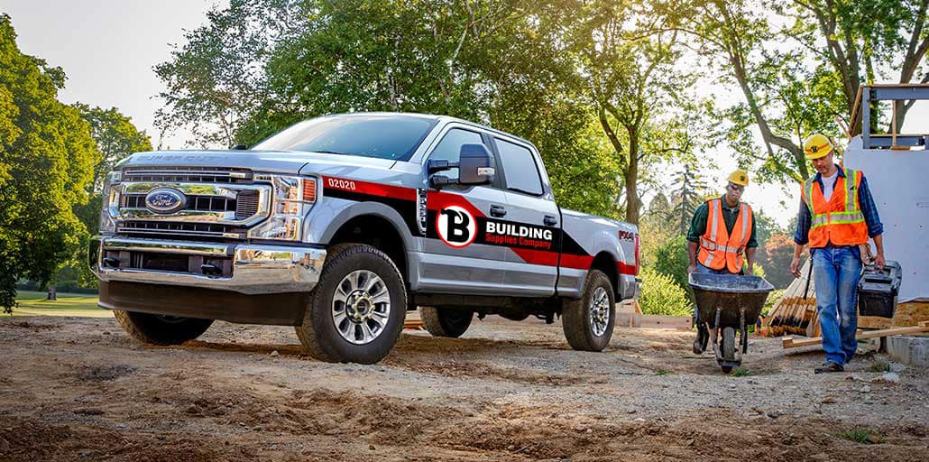 Ford Super Duty pickup with custom graphics printed on the doors.