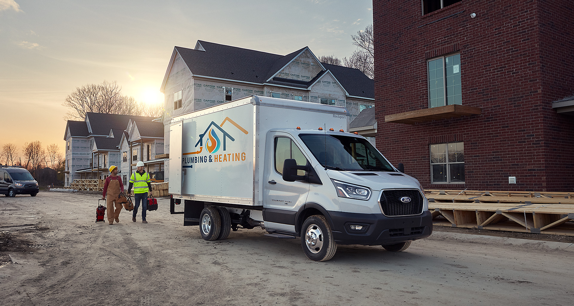 Workers from a heating and cooling company return to their 2020 Ford Transit chassis.