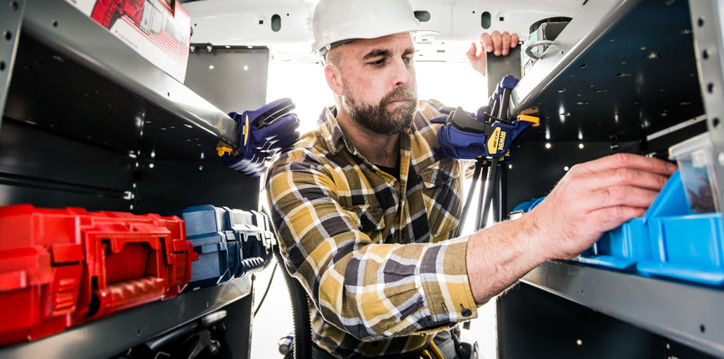 Ford Transit Connect with man looking at equipment