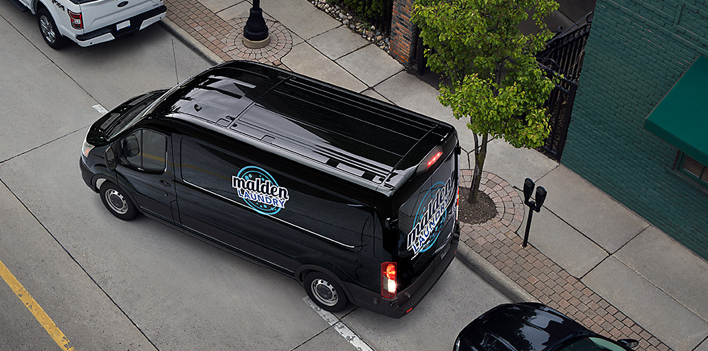 2020 Ford Transit van backing up out of a parking space.