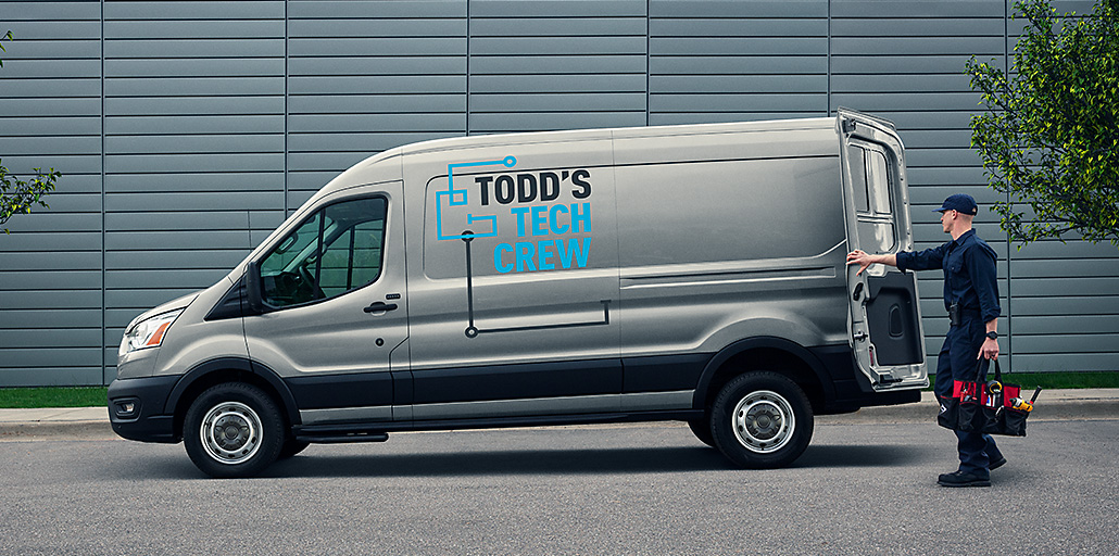 2020 Ford Transit at a construction site with company logo and information printed on the side.